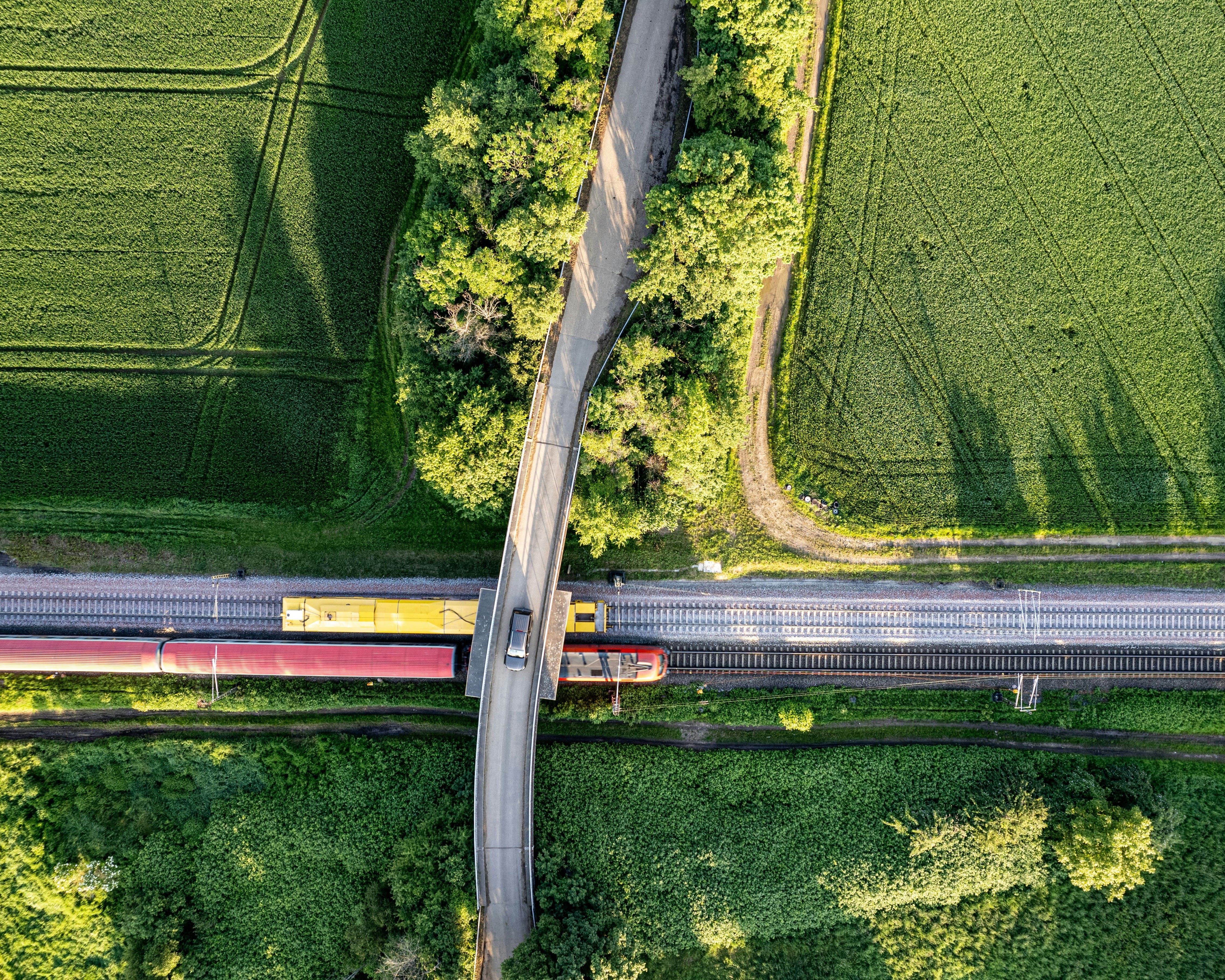 A road and railway overlapping in the German countryside